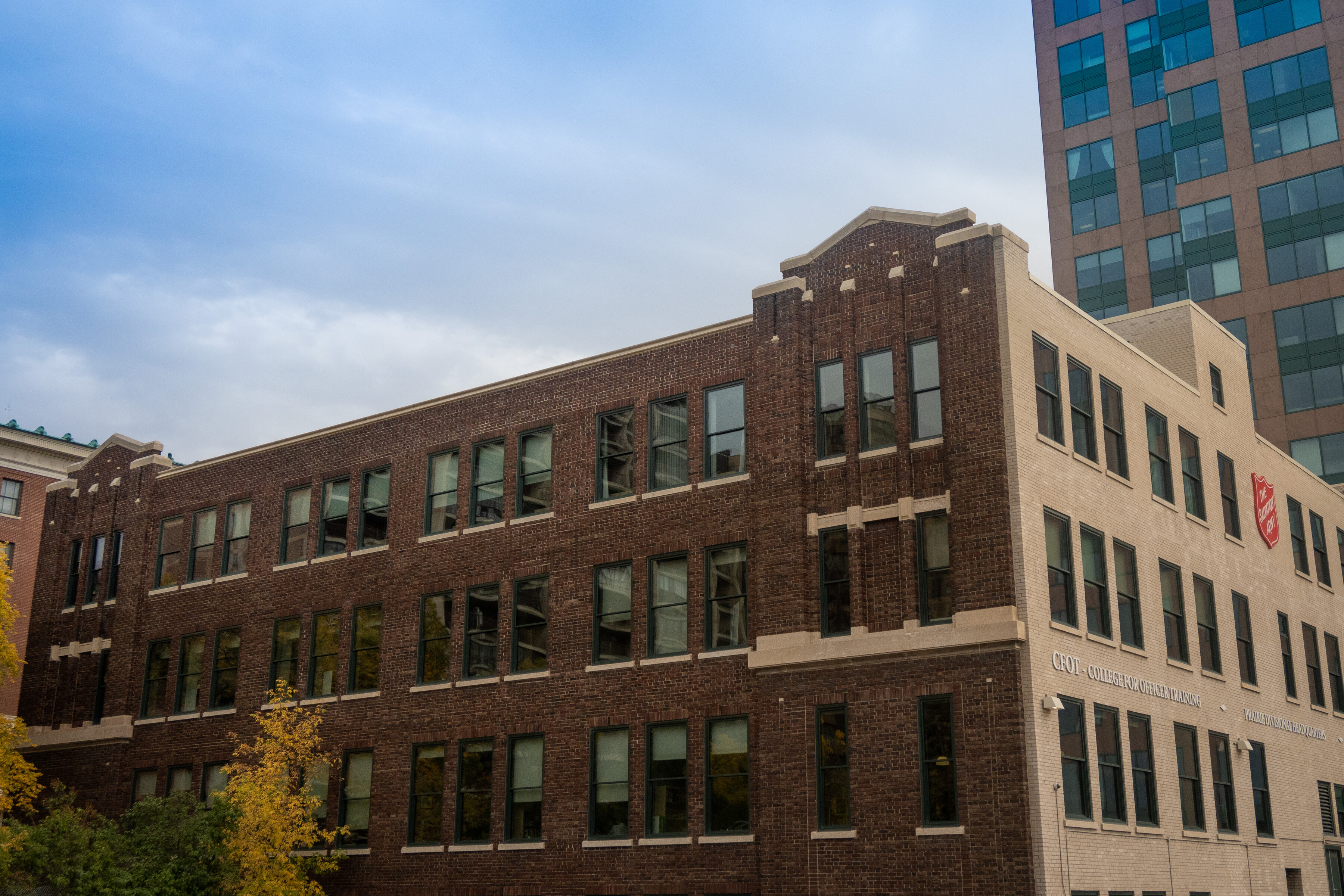 A four-story brick building with large windows across each floor.