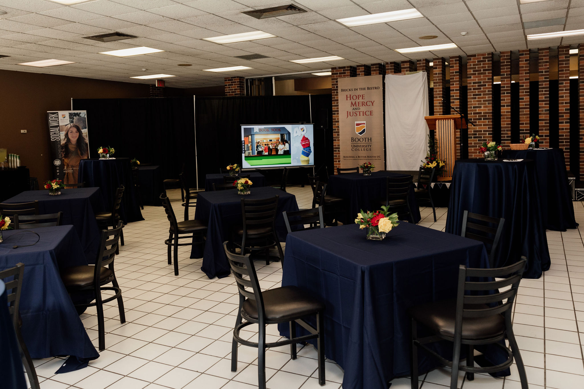 Tables are set with linens and flowers for a special event.