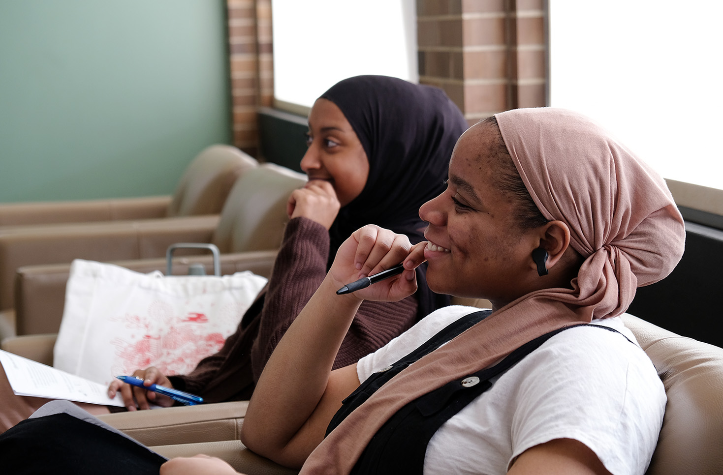 Two international students sitting in a student lounge.