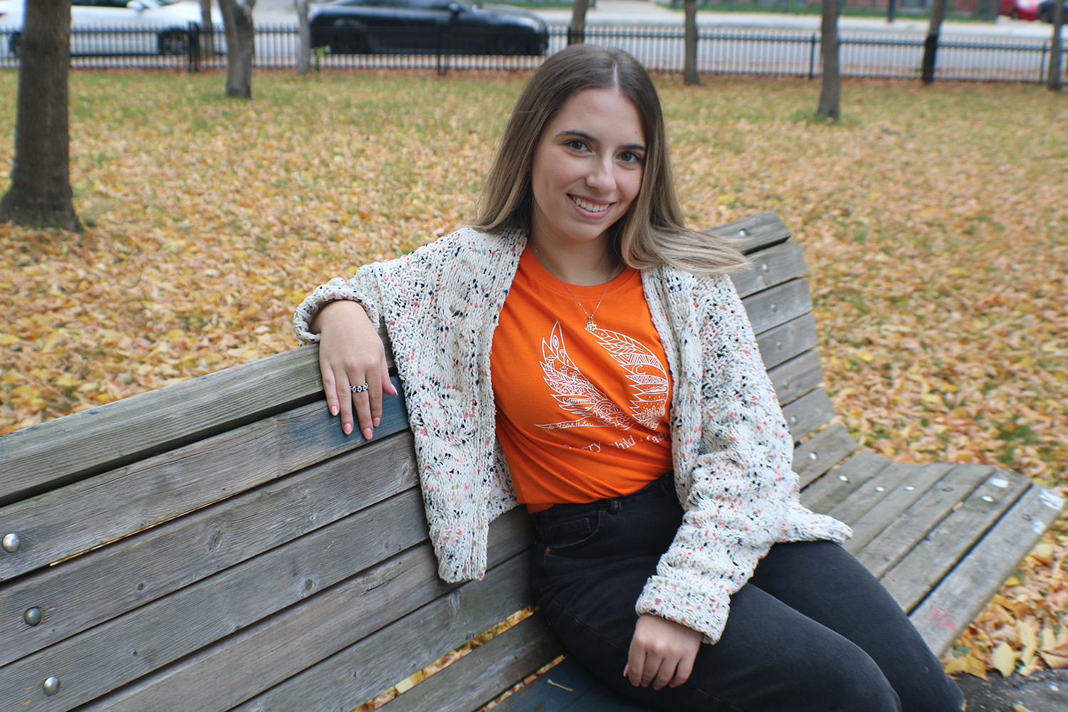 Mishel sitting on park bench.